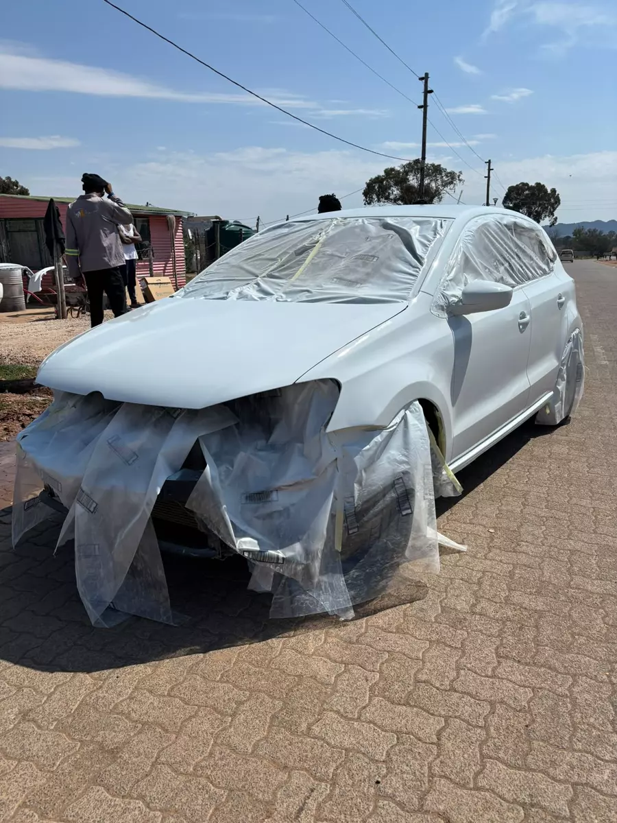 Car masked and covered, ready for spray painting