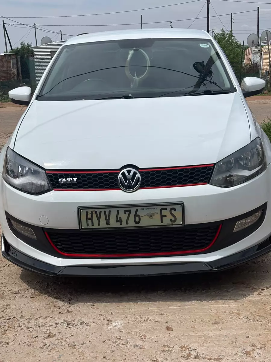 A white Volkswagen Polo GTI parked outdoors after repair work